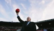 Former Carlton legend John Nicholls holds aloft the match ball